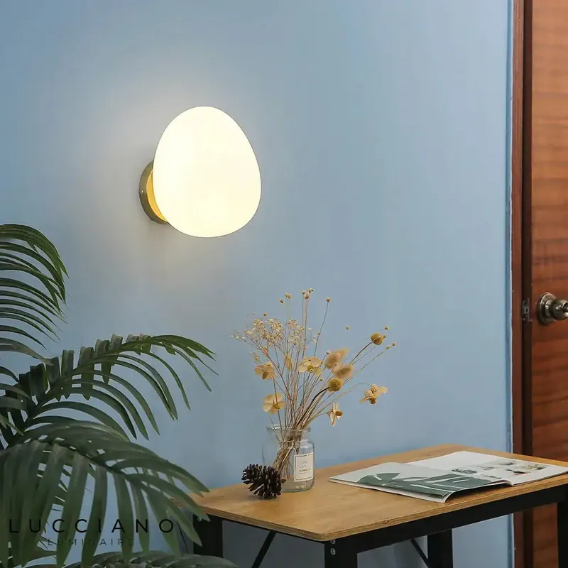 Elegant handcrafted contemporary asymmetrical wall light.