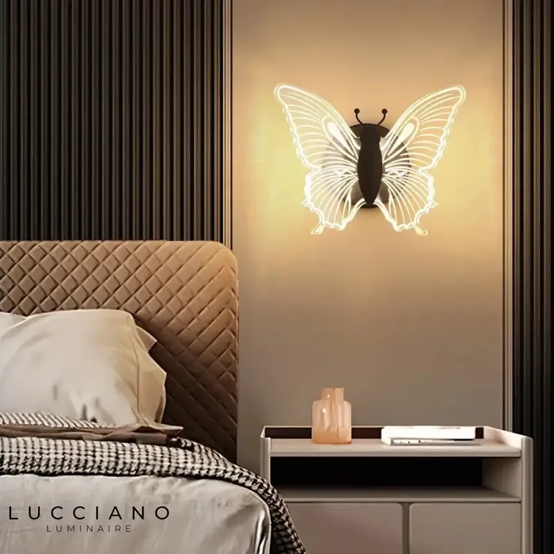 Elegant acrylic LED wall light with butterfly design.