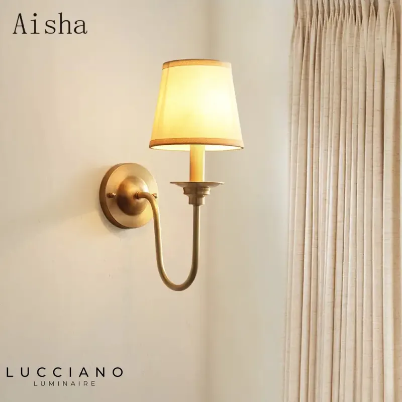 Wall light in golden fabric, luminous elegance.