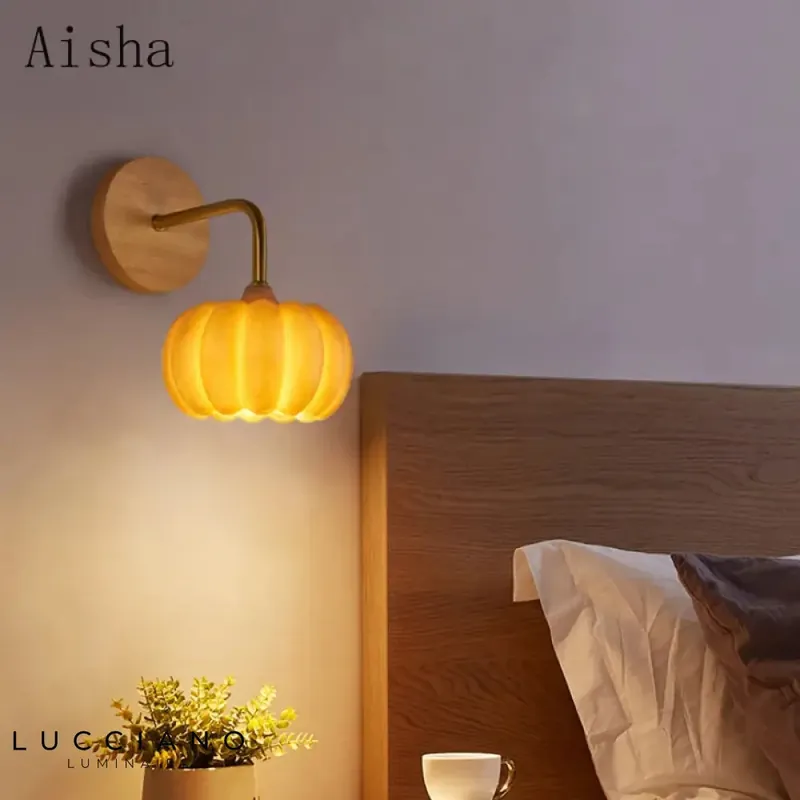 Artisan-designed illuminated pumpkin wall sconce.